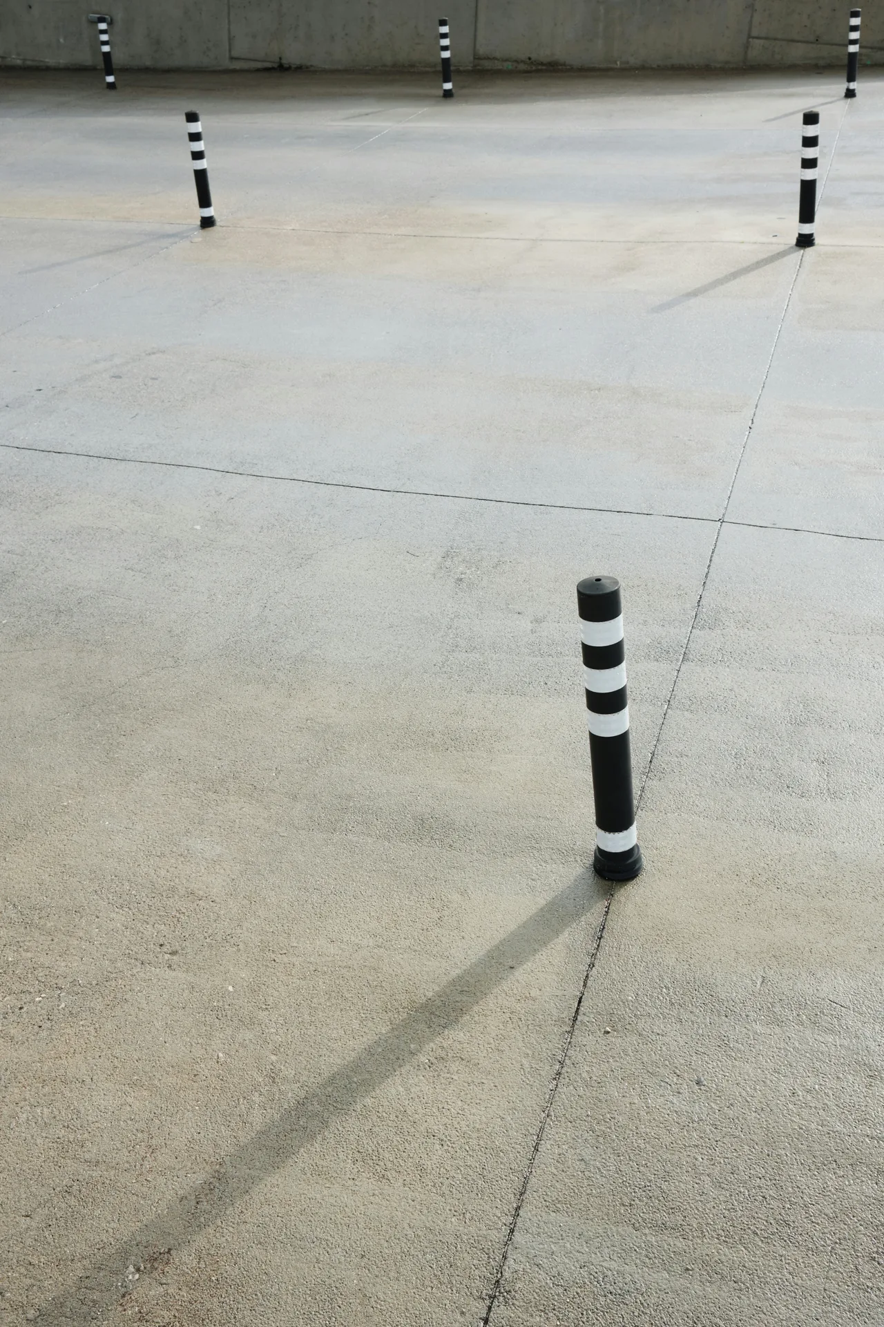 broom-finished concrete parking lot with bollards in Gatineau