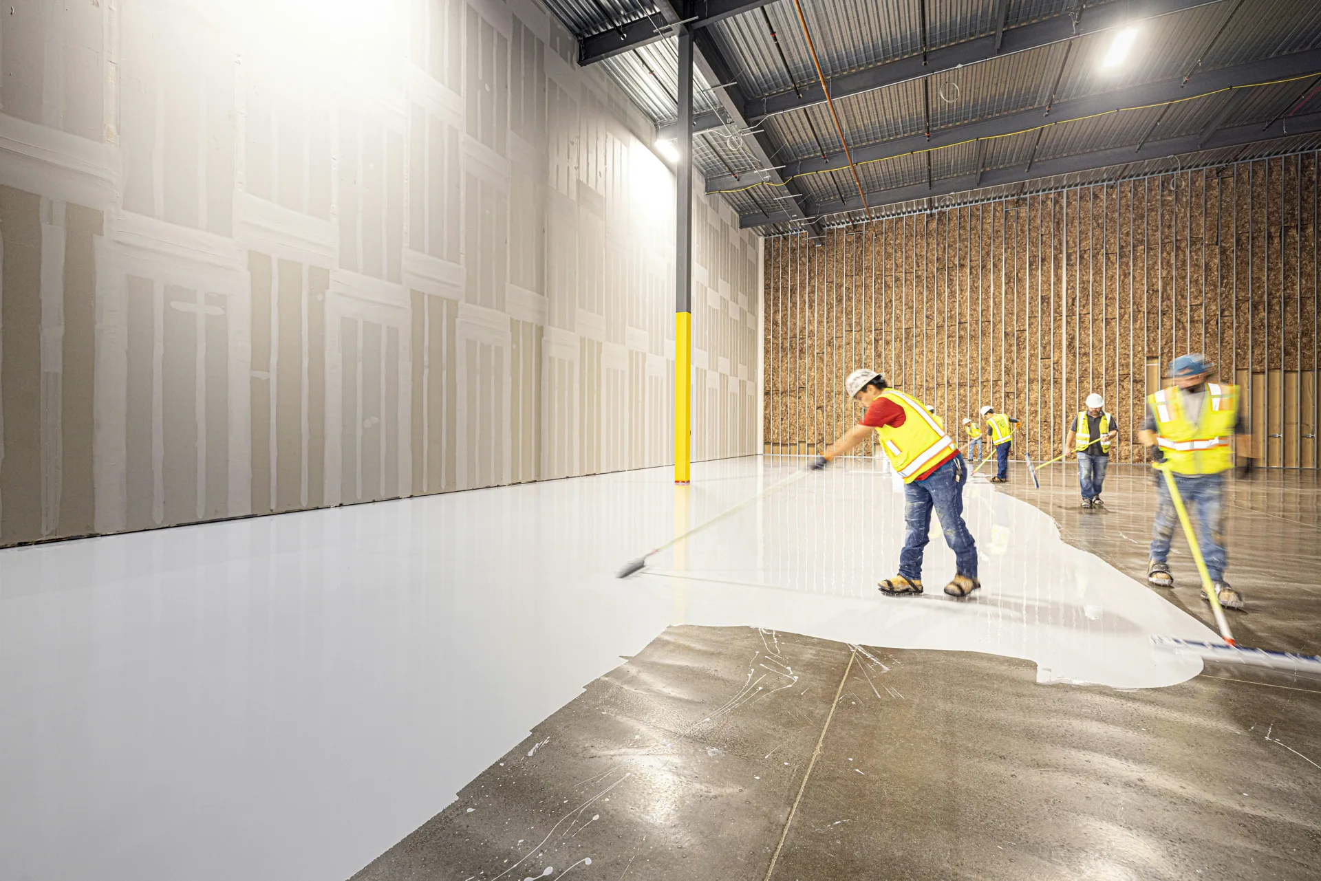 Rust-Oleum coating crew squeegeeing a base coat in Gatineau