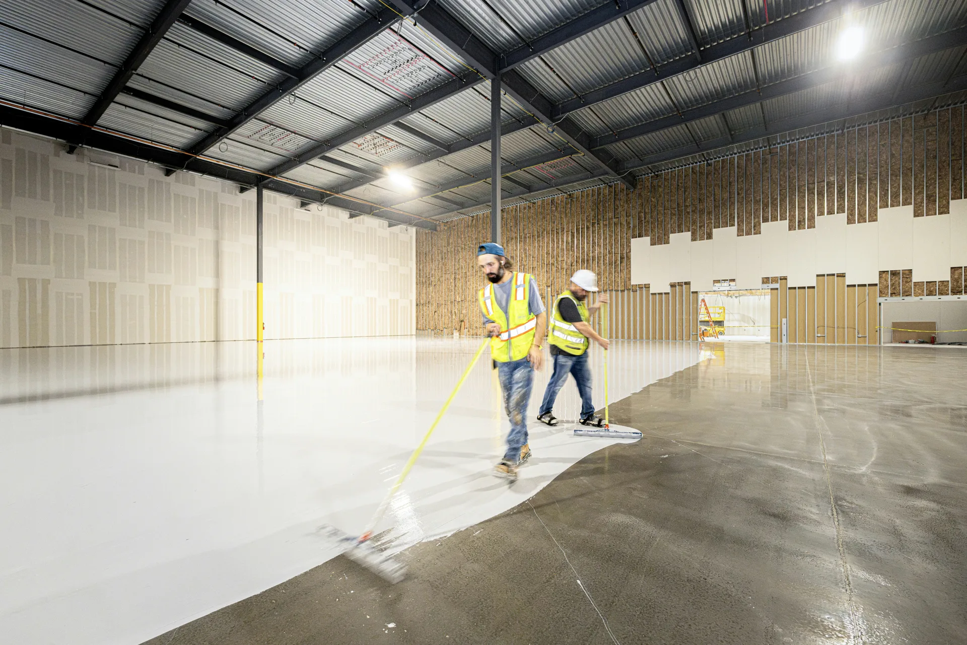 crew rolling epoxy onto a Gatineau garage floor