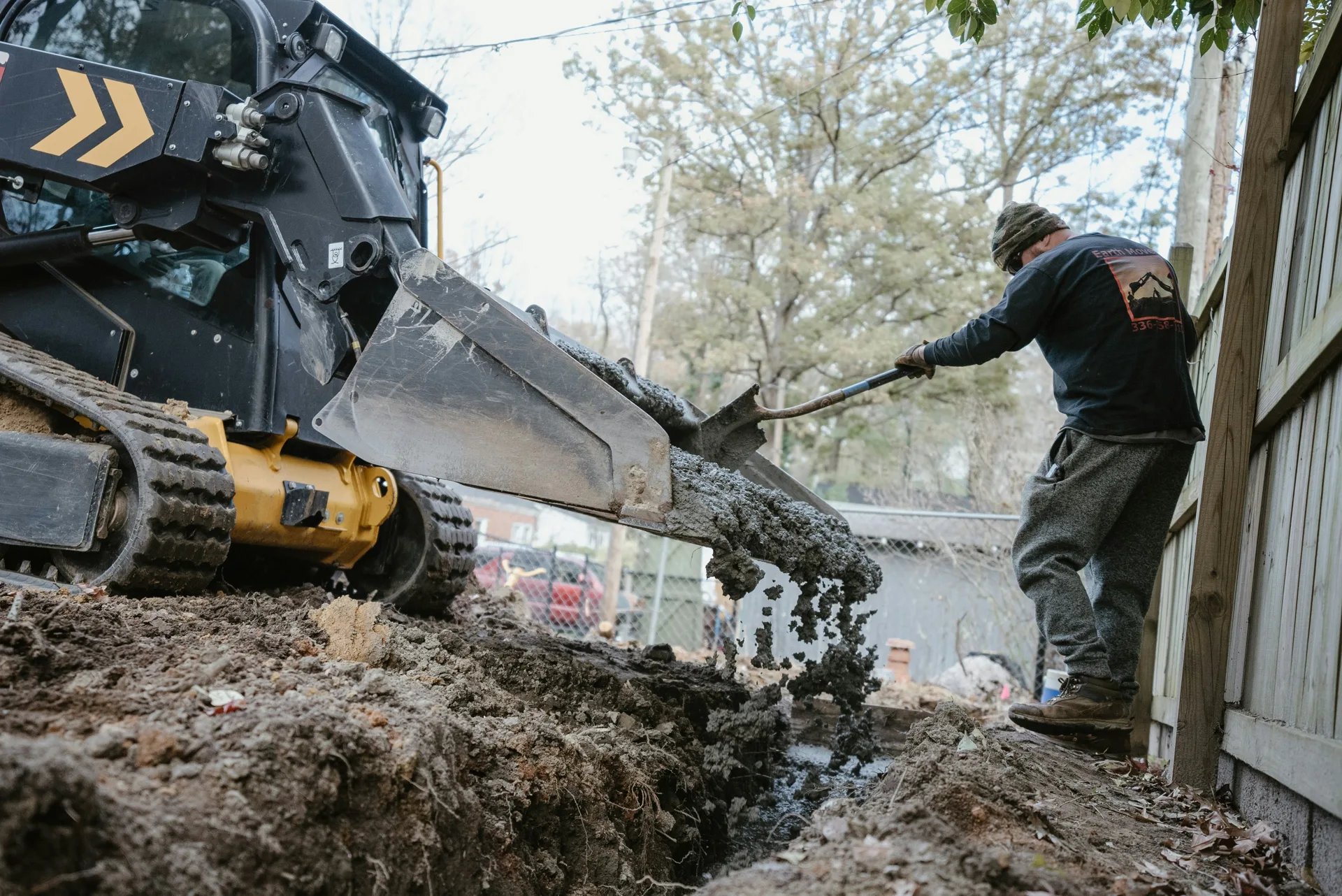 concrete foundation footing pour with a skid steer at a Gatineau site