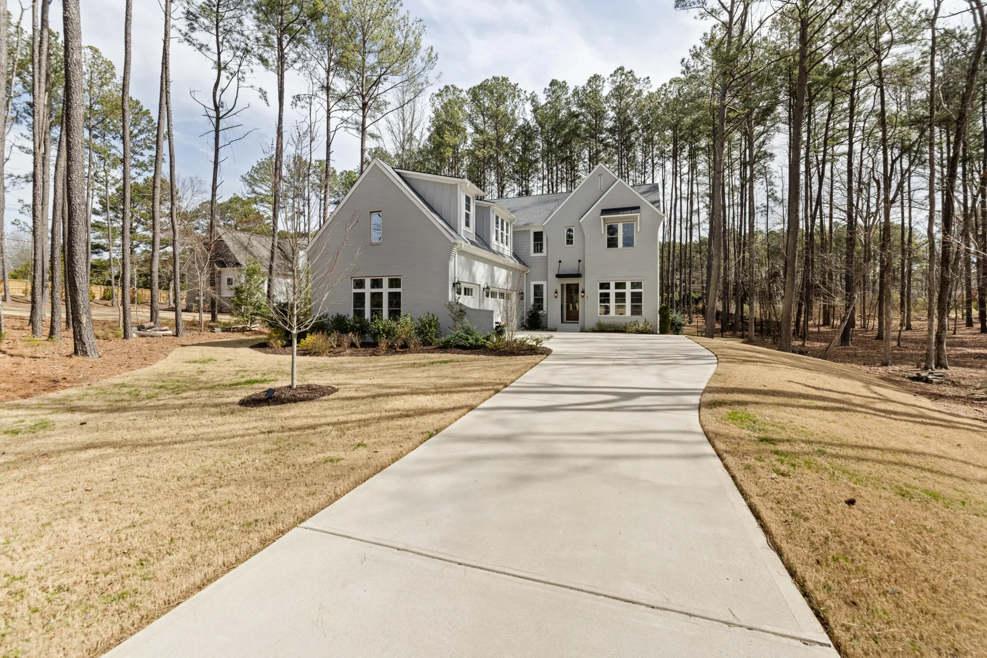 long curving concrete driveway through pines near Kanata