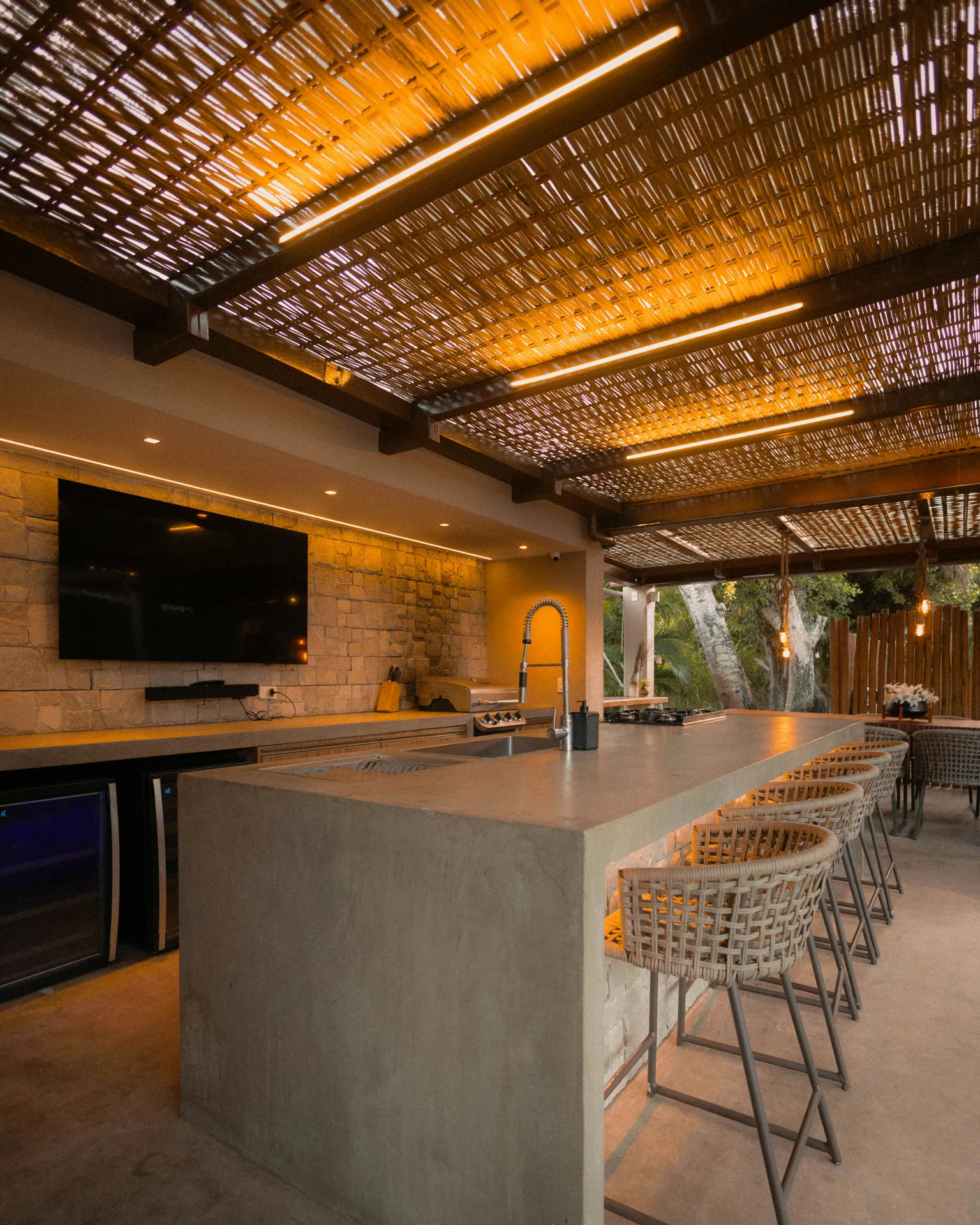 concrete outdoor kitchen bar under a pergola at a Gatineau home