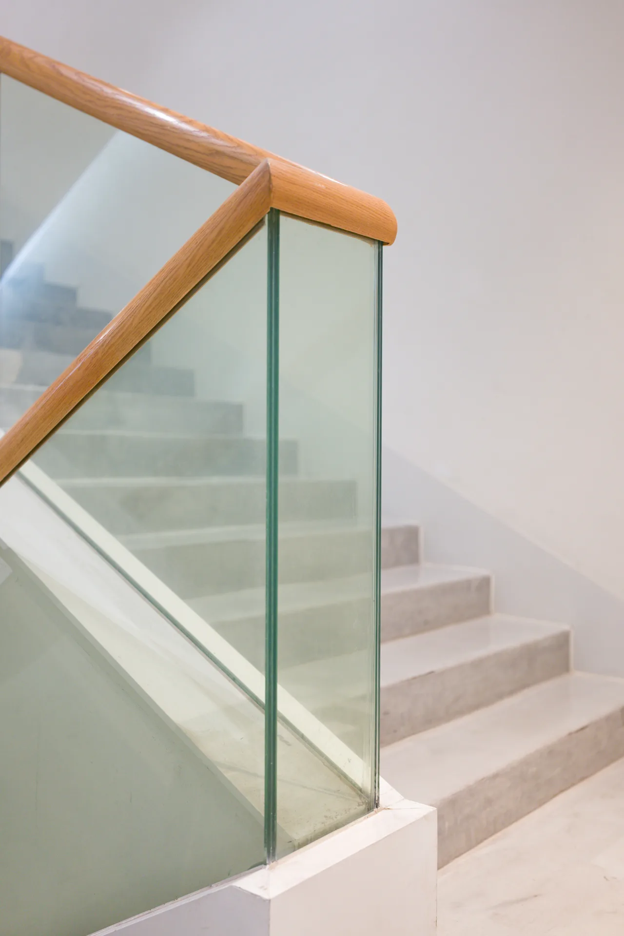 poured concrete staircase with glass railing at a Gatineau home